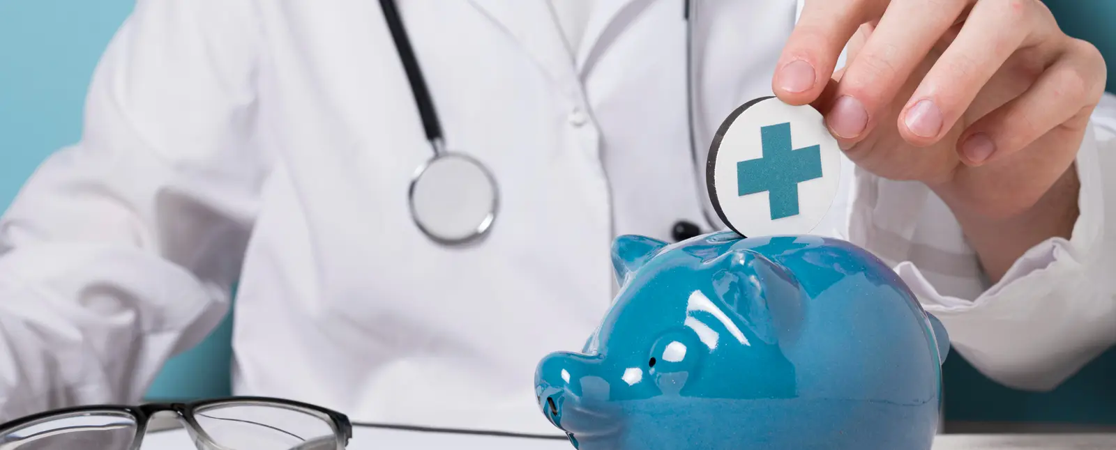 Médico depositando símbolo da saúde em cofre azul em formato de porquinho, representando economia tributária para clínicas médicas e odontológicas por meio da equiparação hospitalar no regime de lucro presumido.